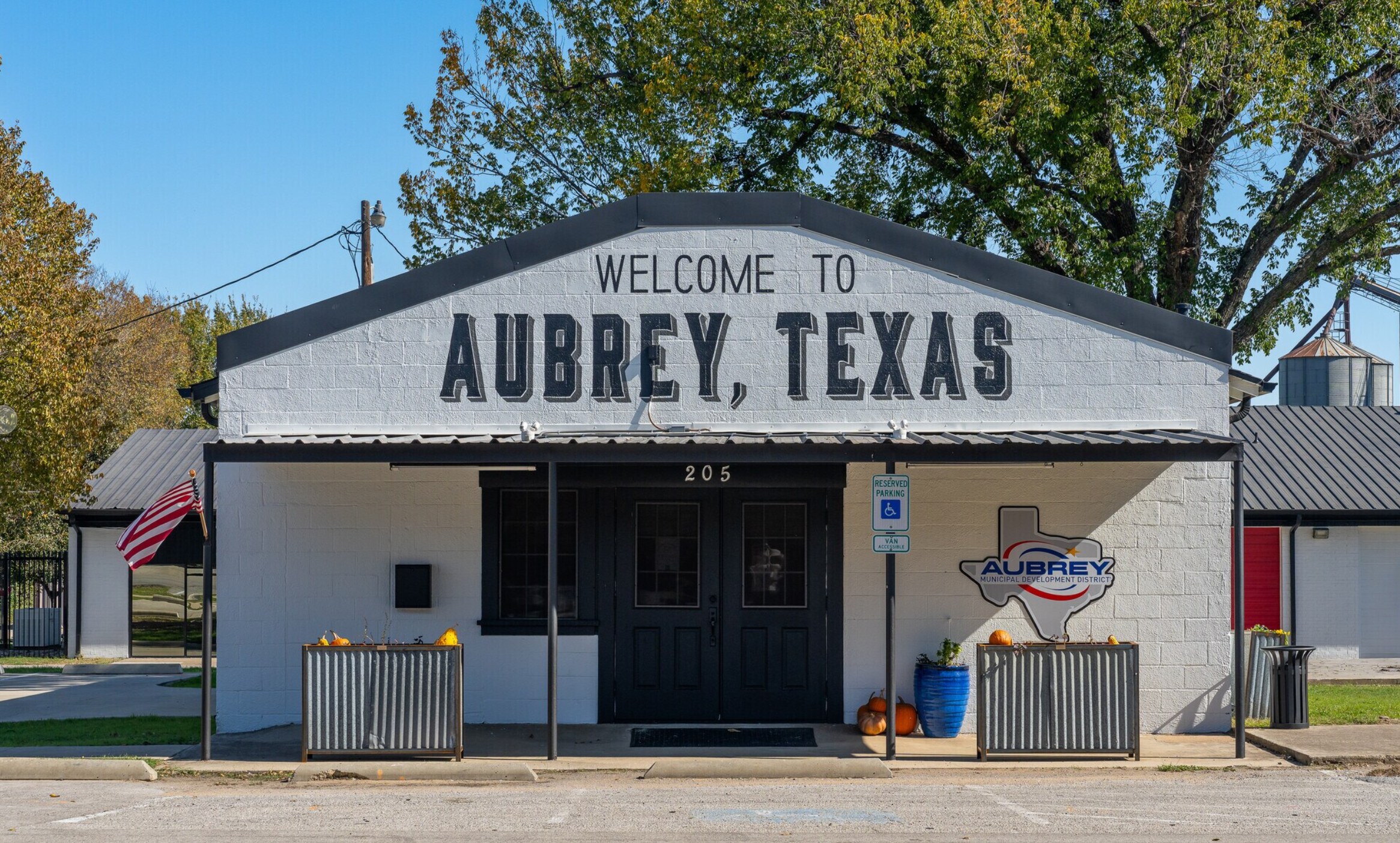Welcome to Aubrey, Texas sign painted on the Aubrey Municipal Development District building