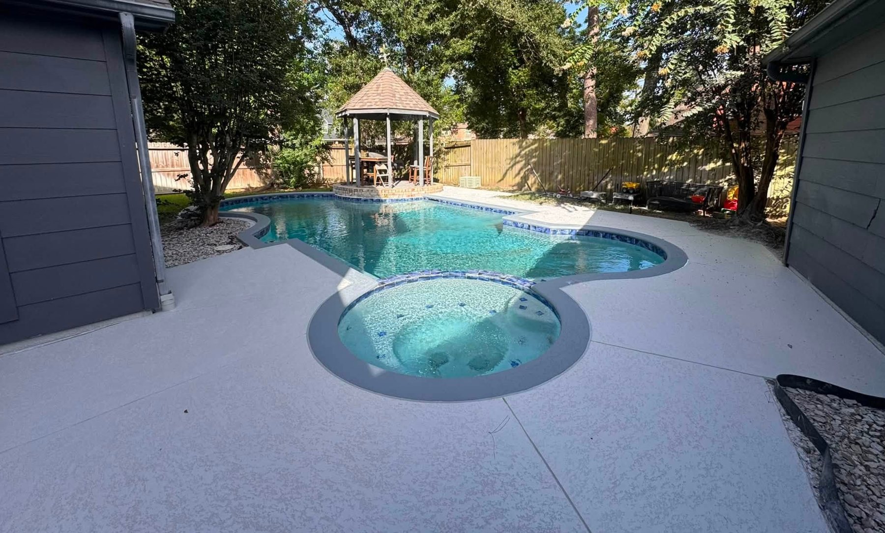 Same pool deck after renovation with new smooth light gray coating