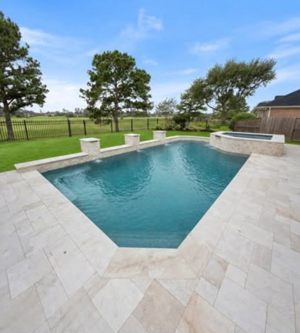 Same pool after deck renovation with new cream travertine pavers