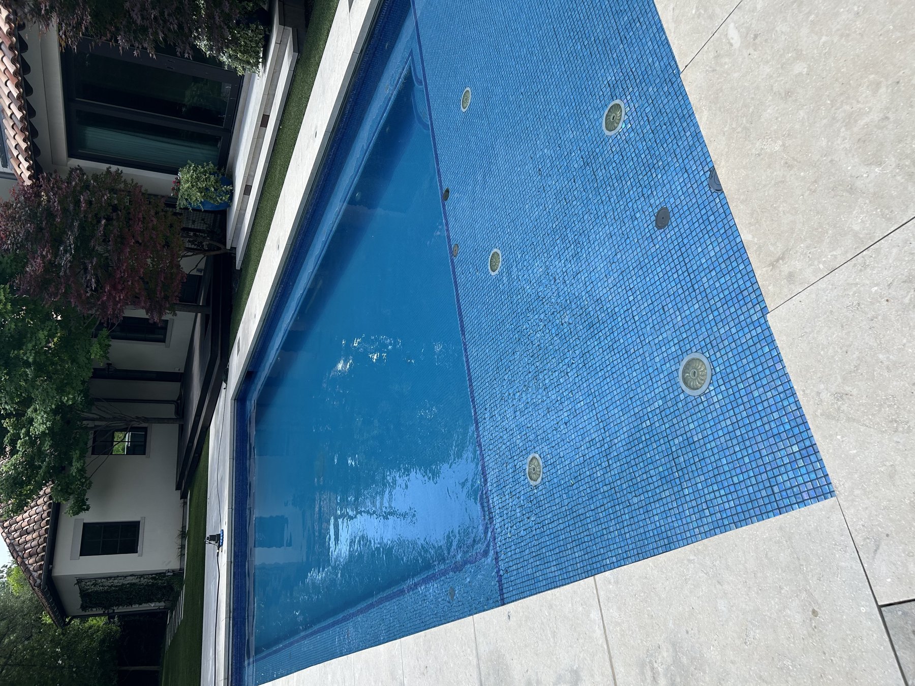 Full pool remodel with new blue glass tile finish and in-floor cleaning system, North Texas