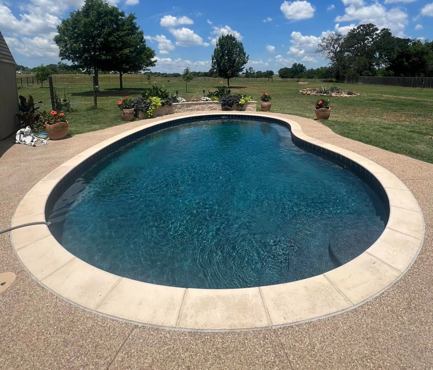 Same pool filled with water after Midnight Blue pebble replaster
