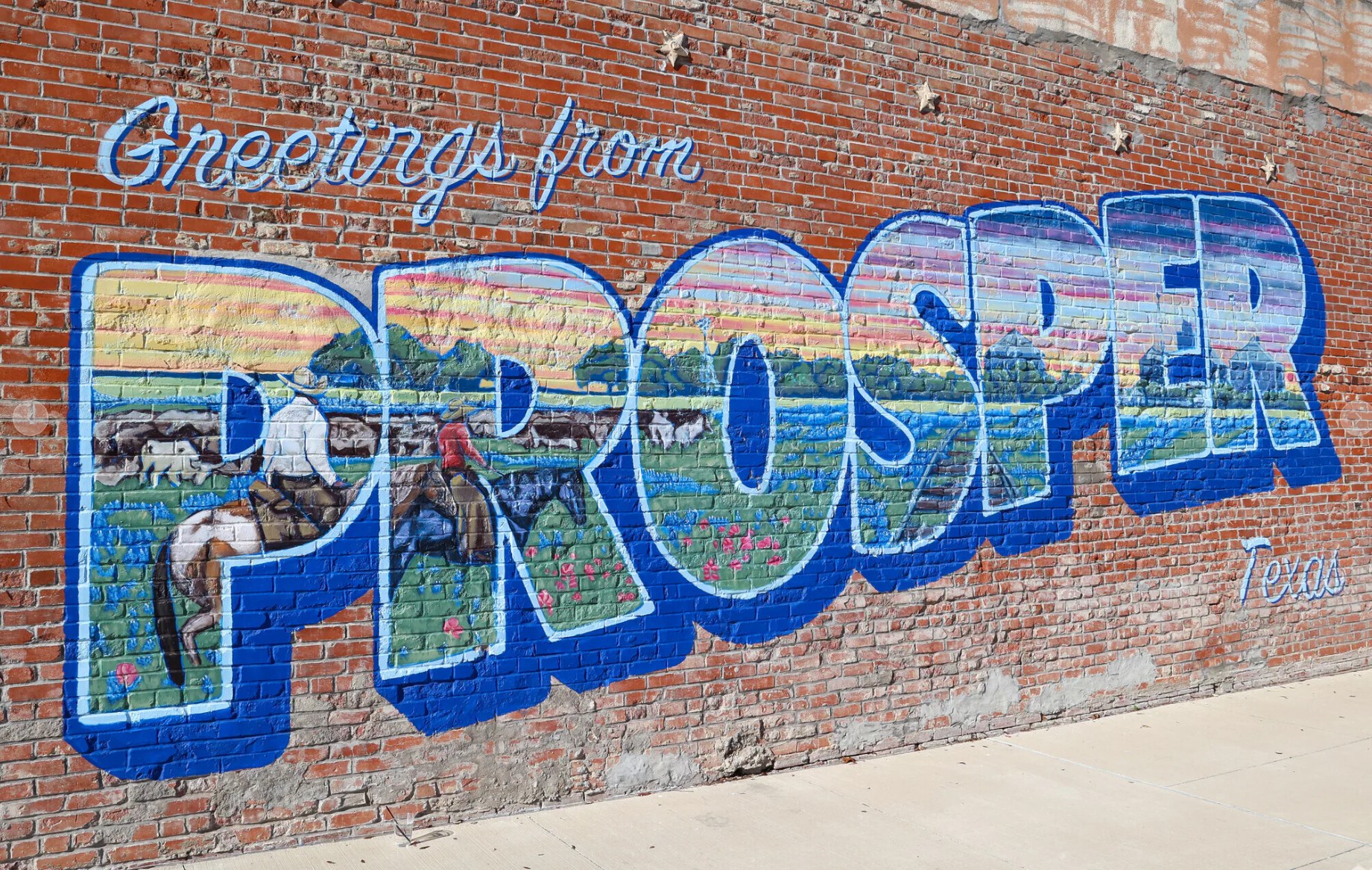 Greetings from Prosper, Texas mural painted on a downtown Prosper brick wall