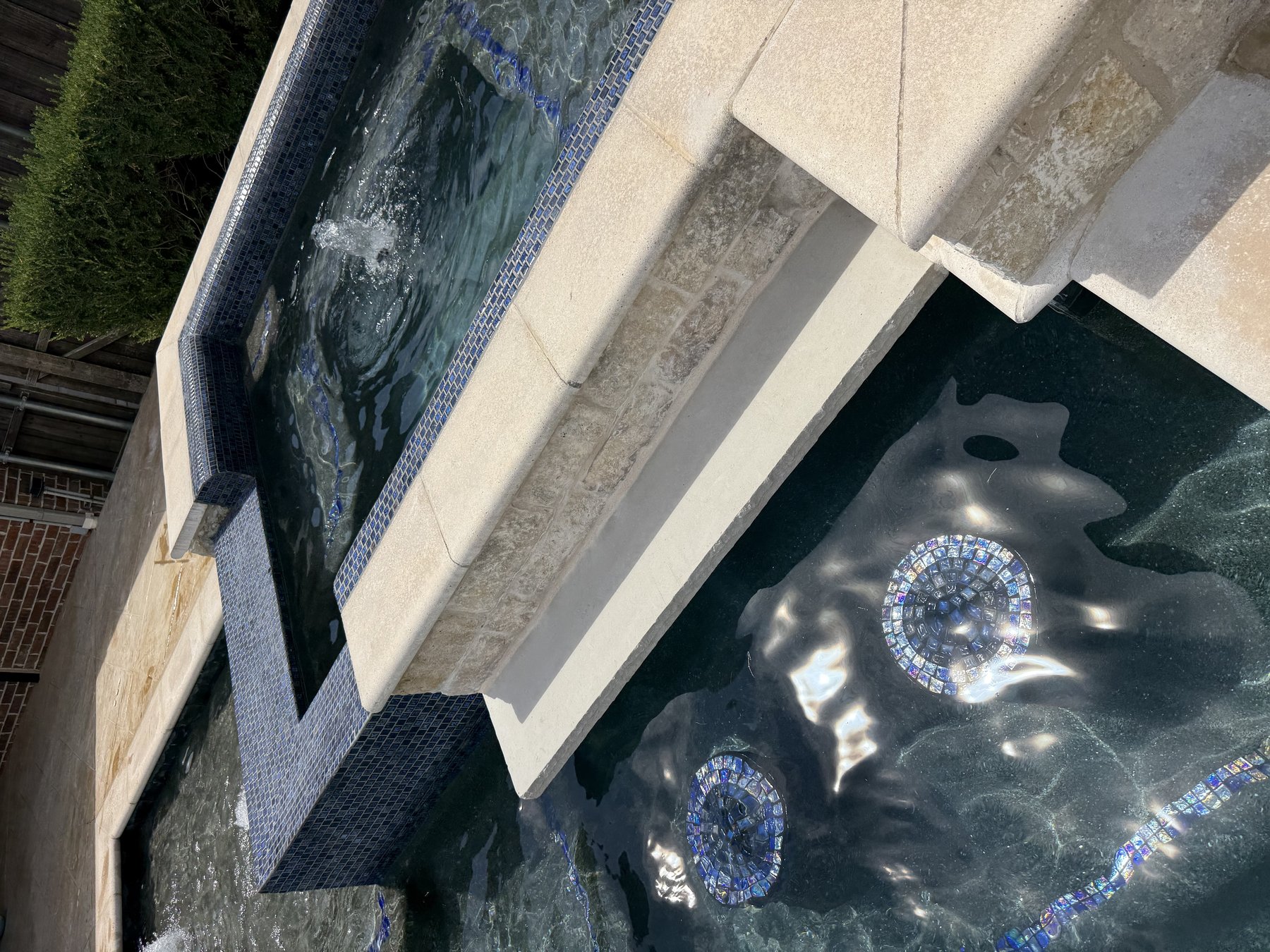 Remodeled raised spa with new glass tile and bubbler water feature