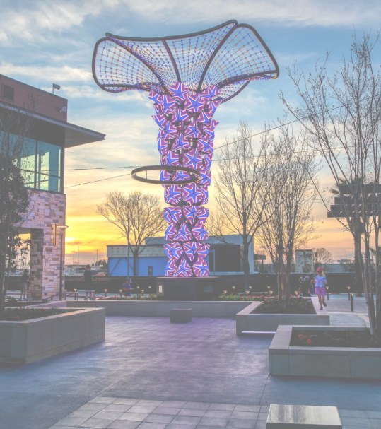Illuminated public art sculpture at sunset in The Colony, Texas