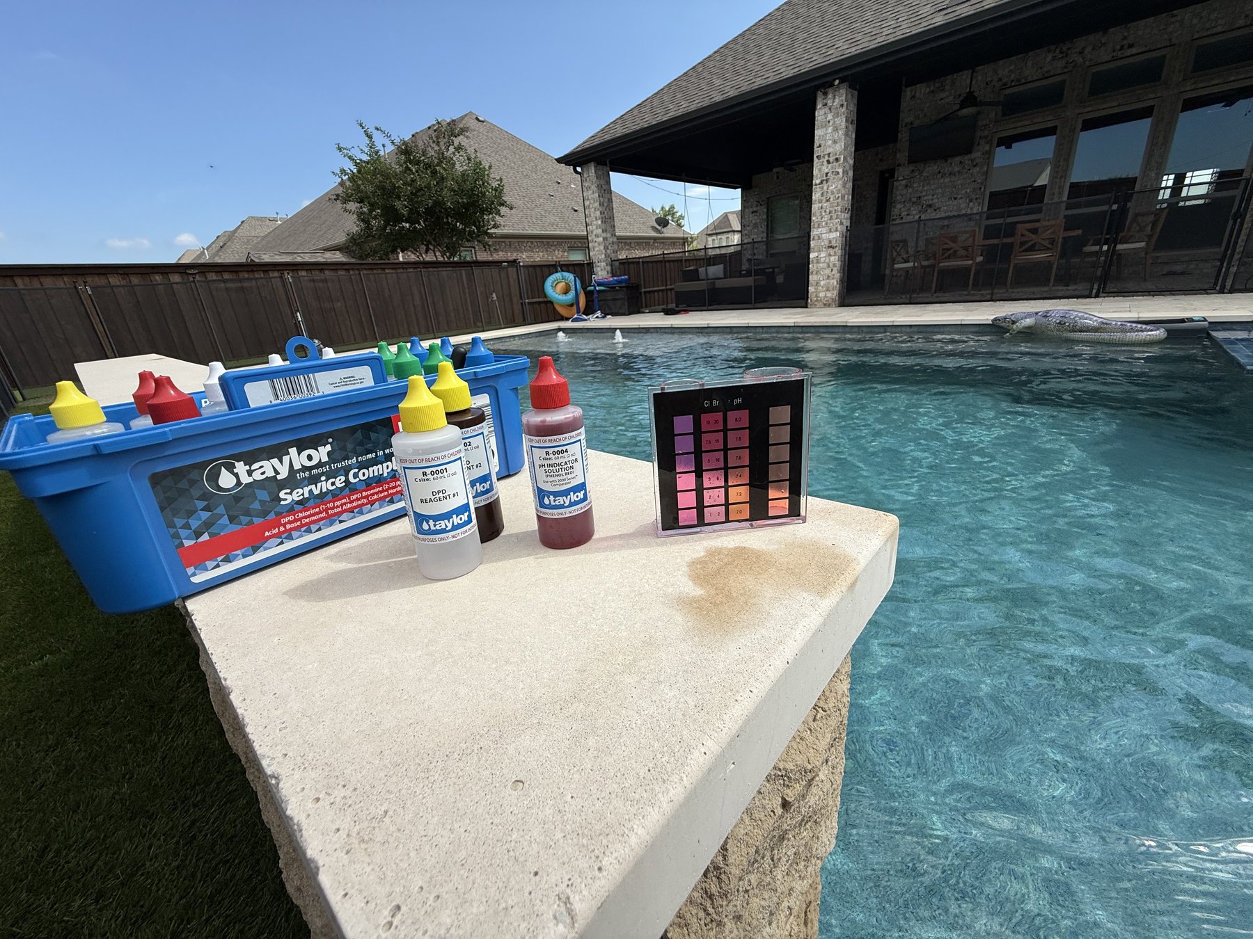Taylor water testing kit used to check chlorine, pH and alkalinity during a weekly pool service visit